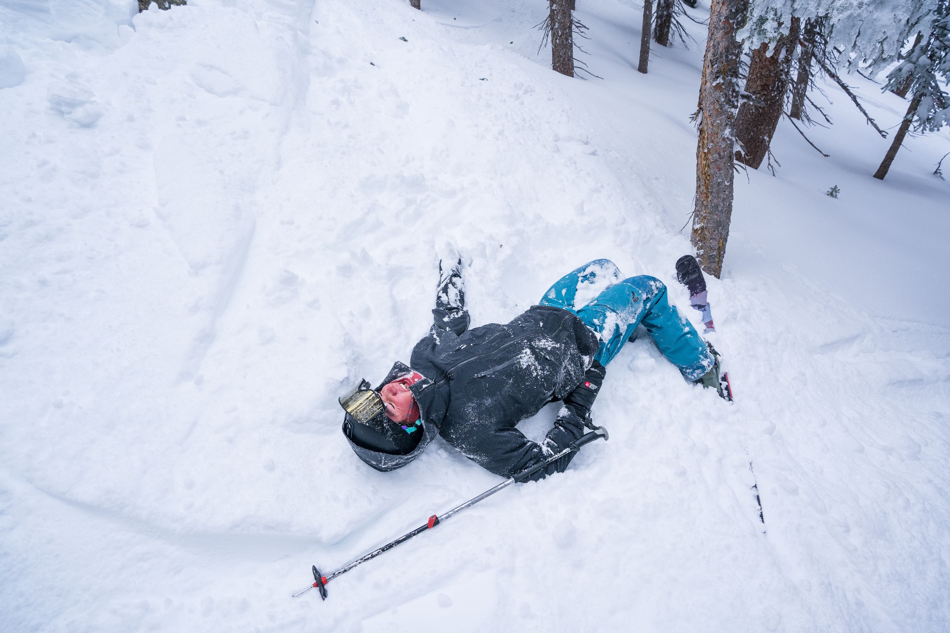 Skier laying in the snow after a crash landing