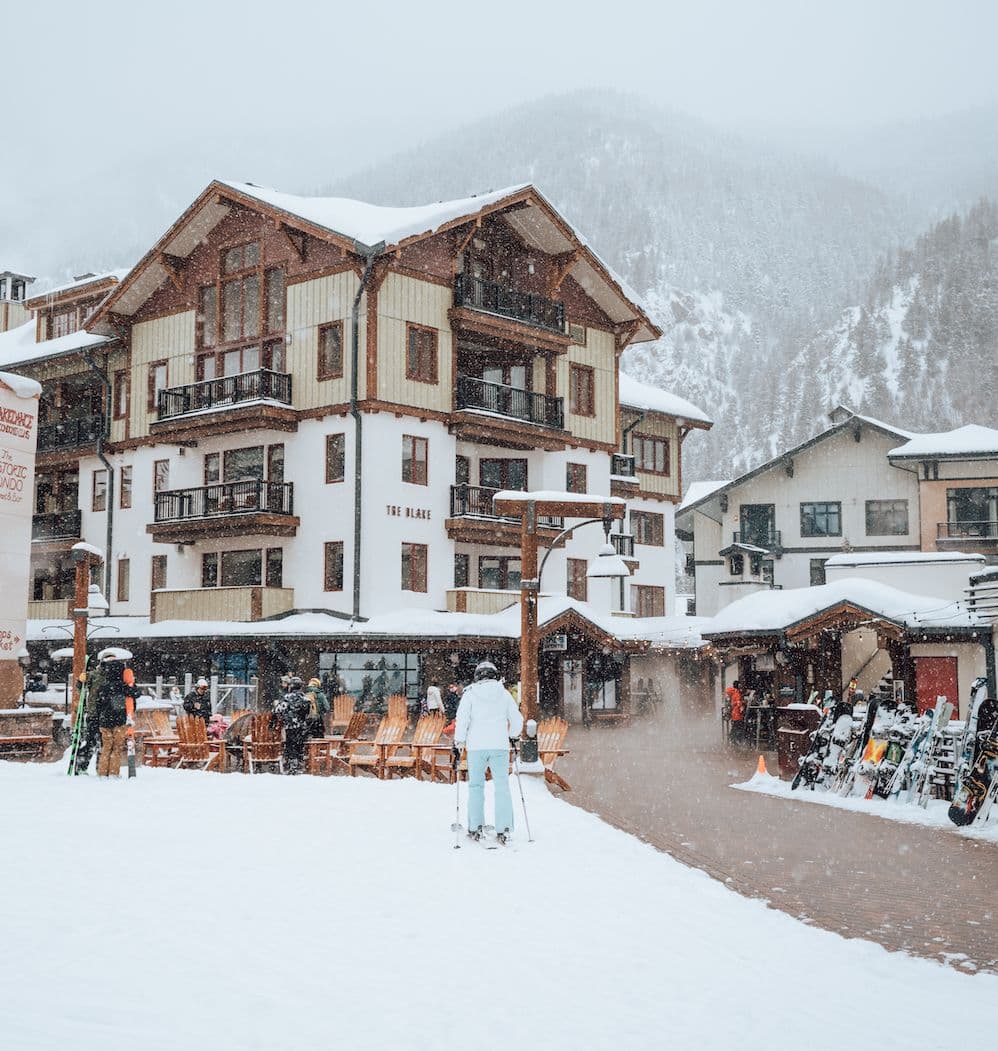 The Blake hotel at Taos Ski Valley viewed from ski beach at the base of Lift 1 covered in snow