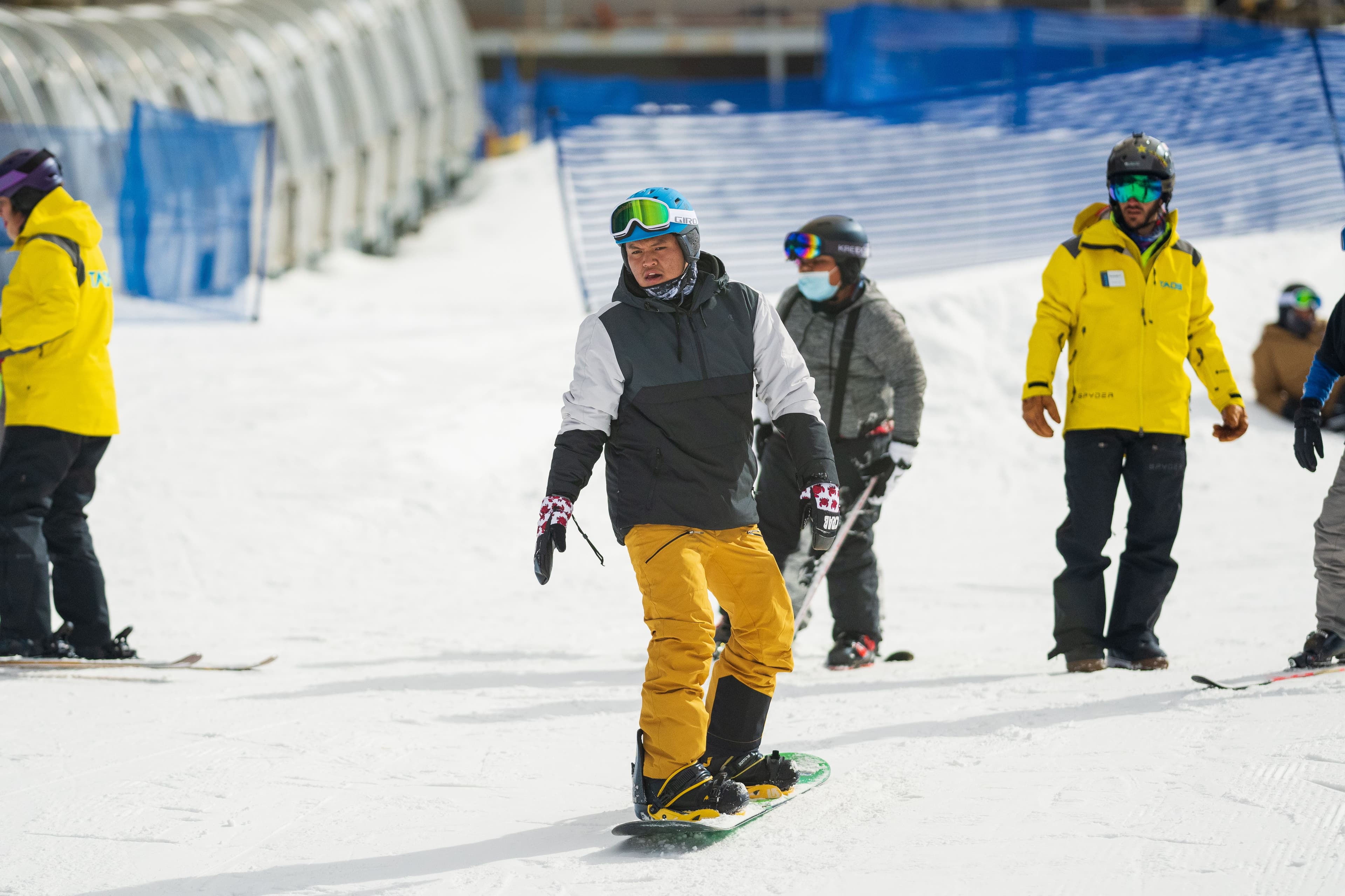 A snowboard instructor teaches a student how to snowboard at Taos Ski Valley.