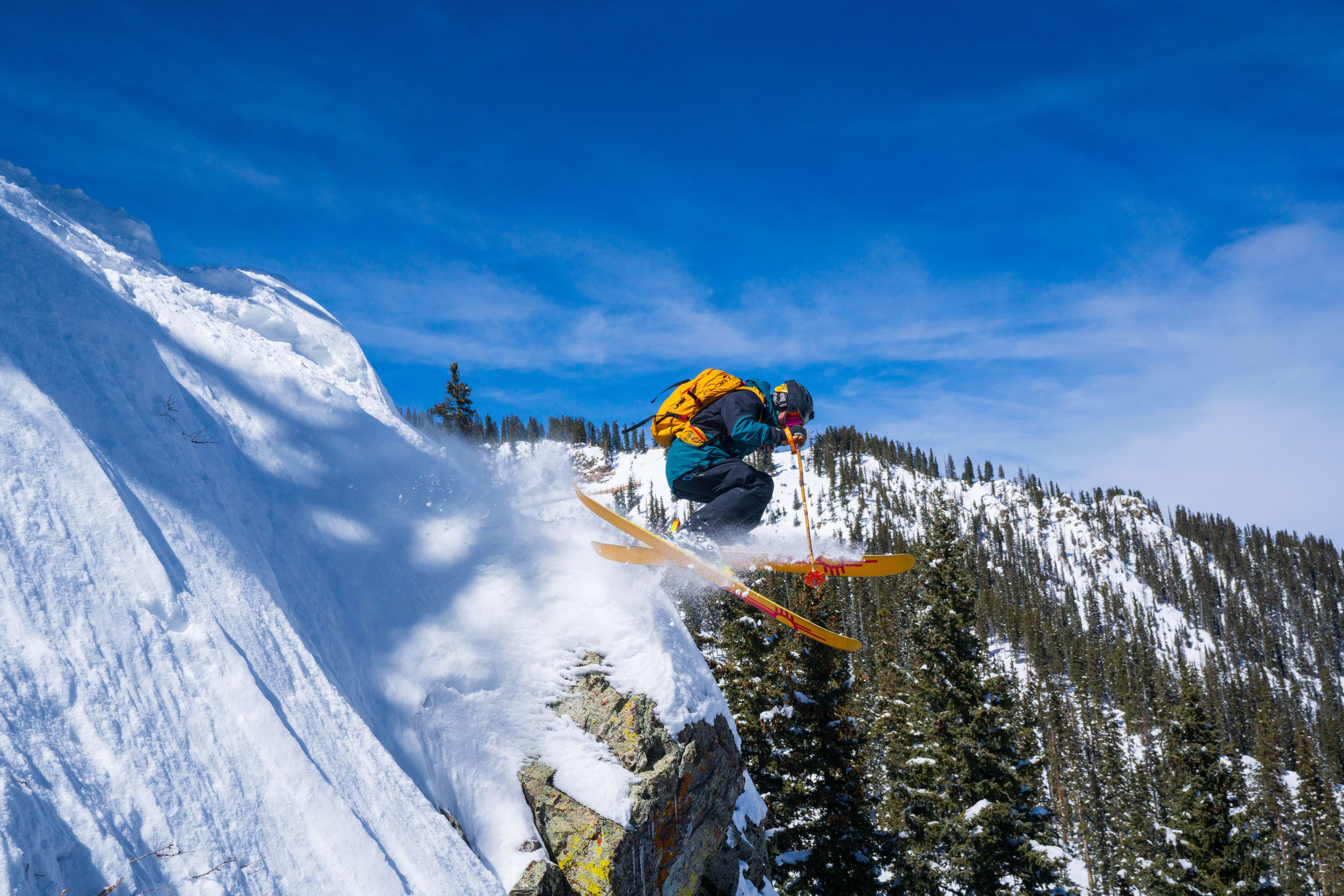 Skier sailing off a jump on a steep run at TAOS Ski Valley