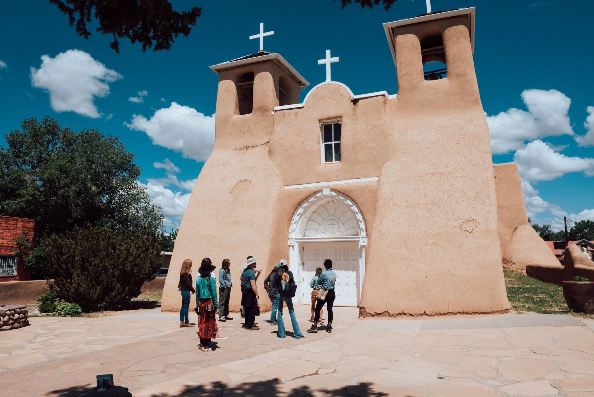 A tour group in front of the San Francisco de Asís Mission Church in Ranchos de Taos, New Mexico.