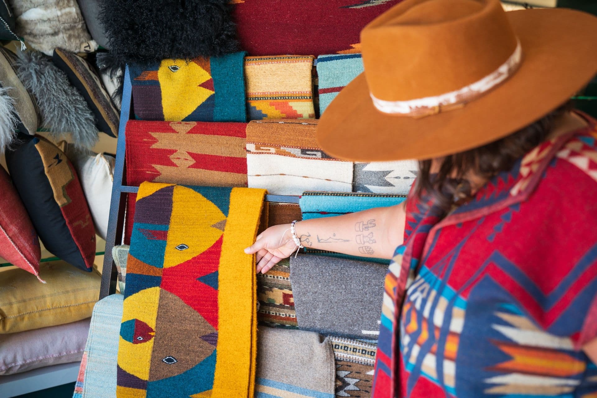 Woman admiring southwestern style textiles in shop at Taos Ski Valley