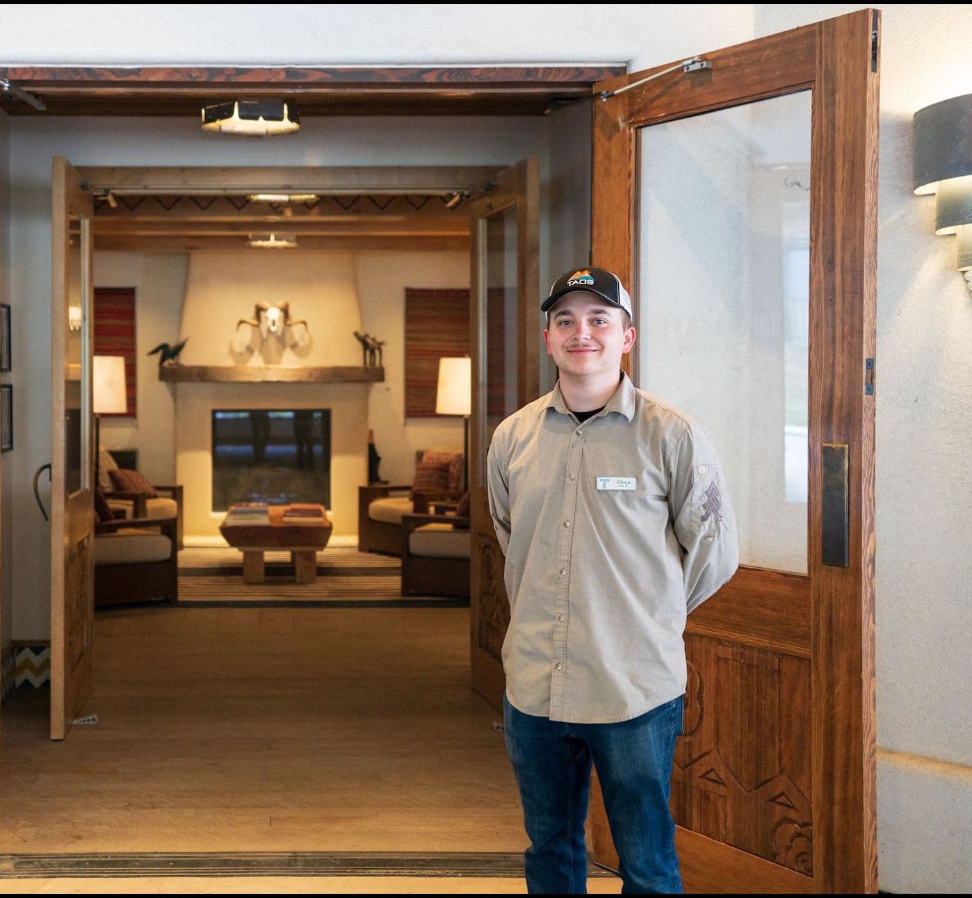A staff member of The Blake stands in front of the lobby of The Blake.