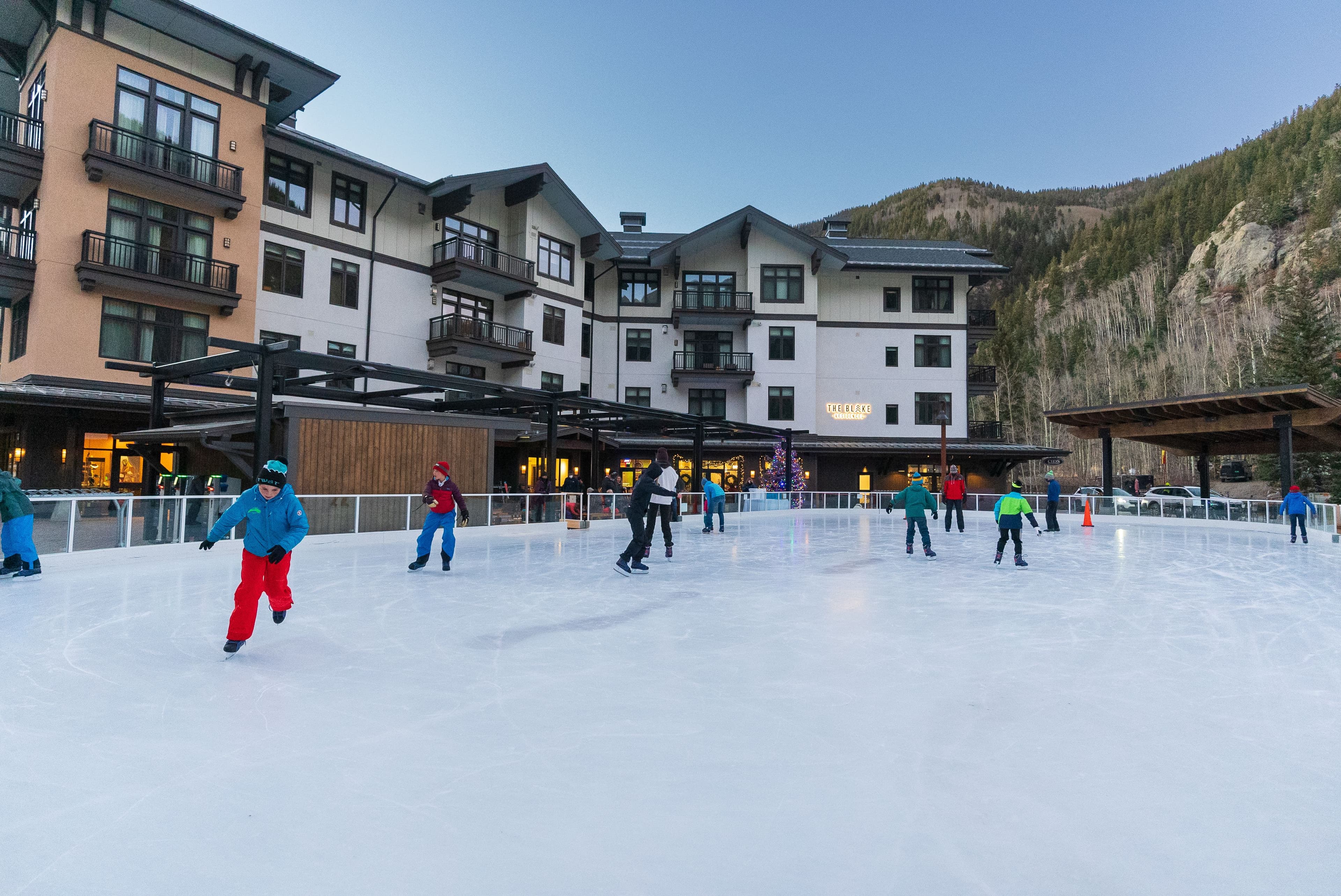 Guests skating around the Eis Haus ice rink at Taos Ski Valley