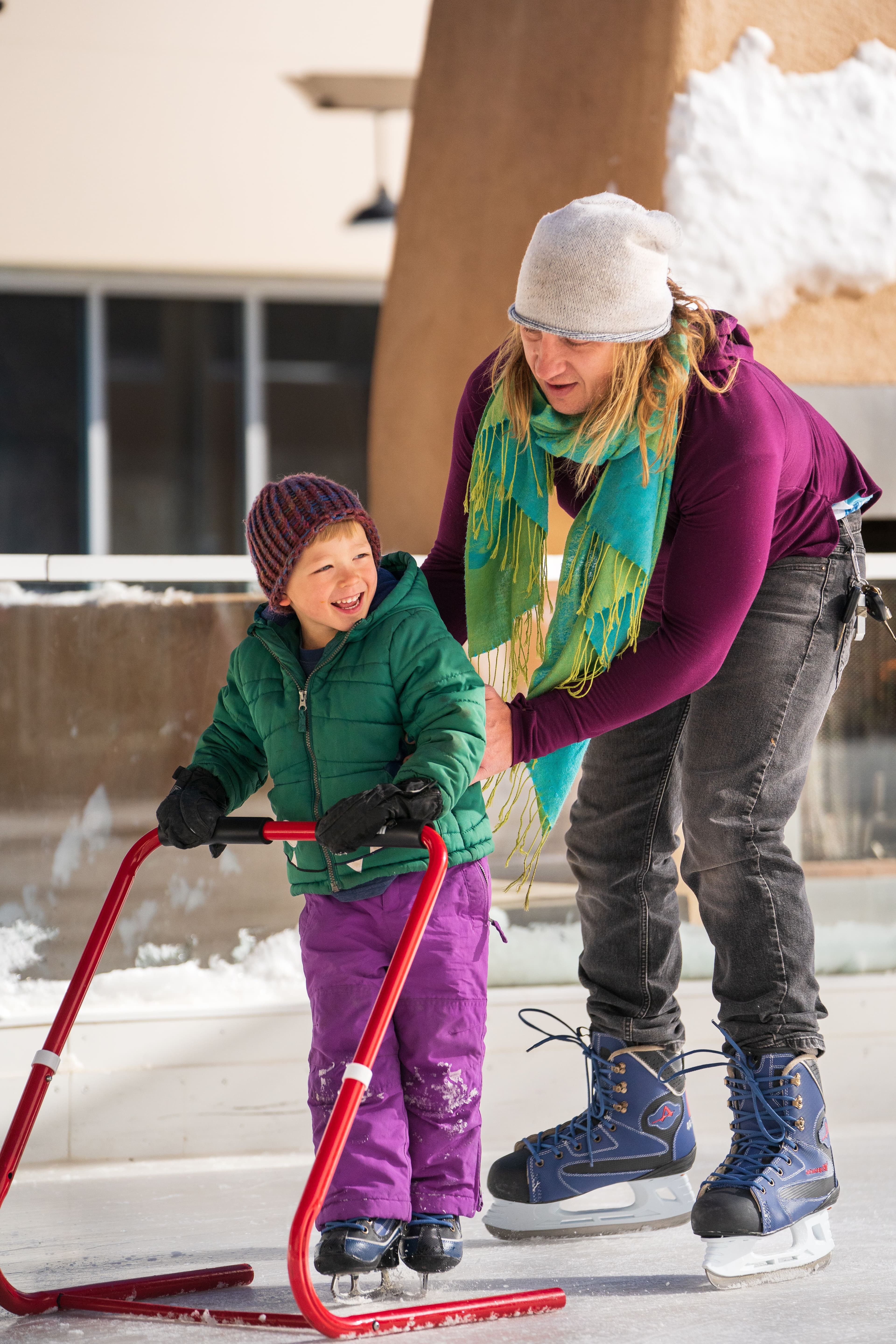 A woman ice skating with her child in the Eis Haus skating rink.
