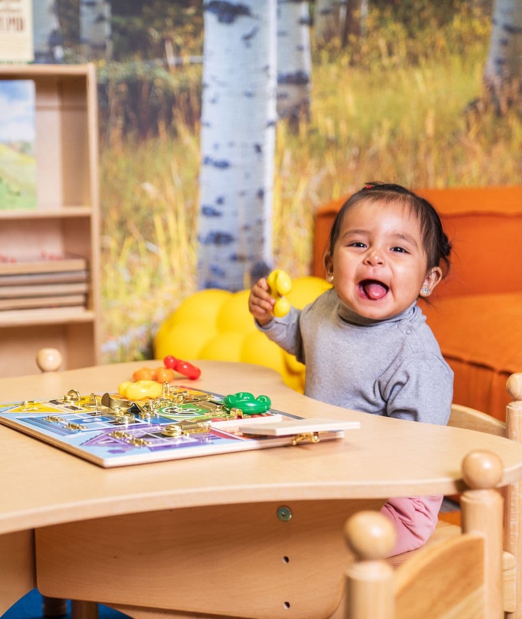Little girl enjoying the books at the childcare facility at Taos Ski Valley