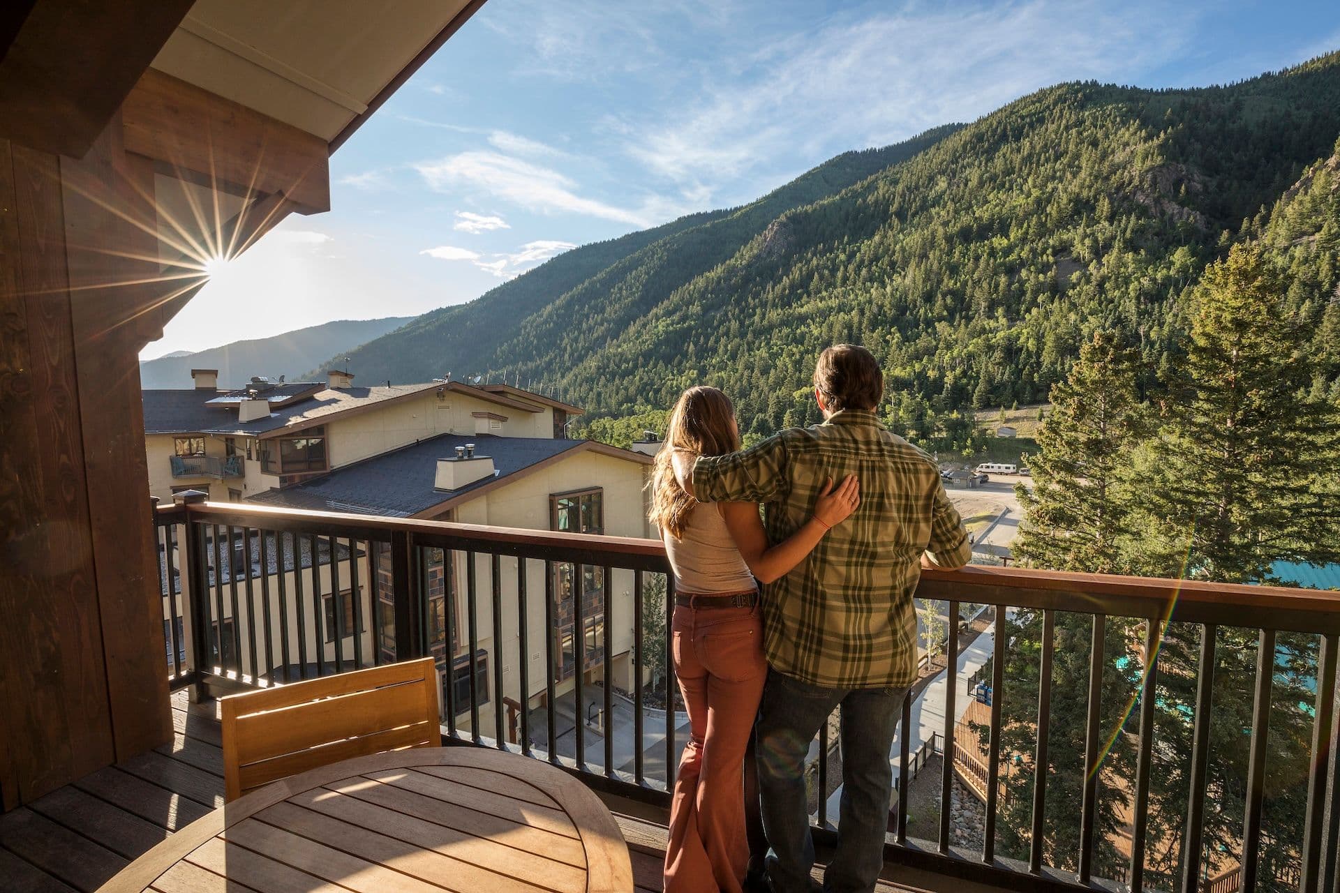 Couple standing on balcony at The Blake overlooking the wilderness