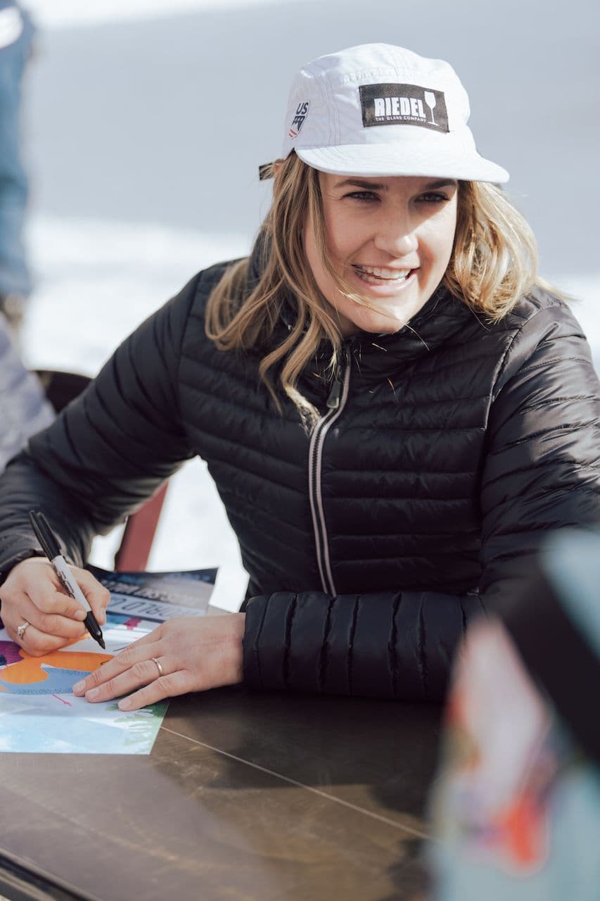 Paula Moltzan autographing flyers at the World Pro Ski tour in Taos Ski Valley
