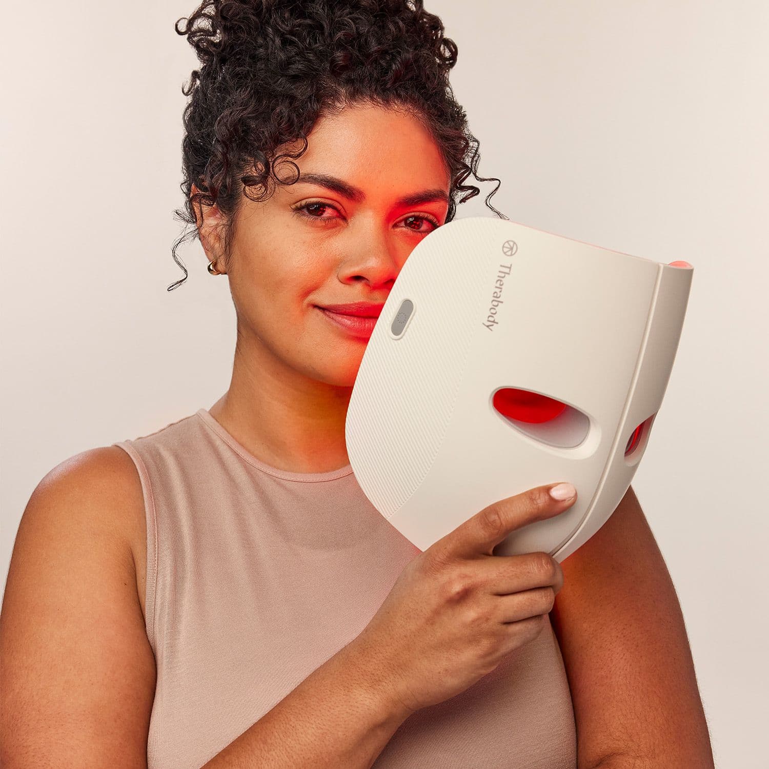 Women holding Therabody Red Light Mask