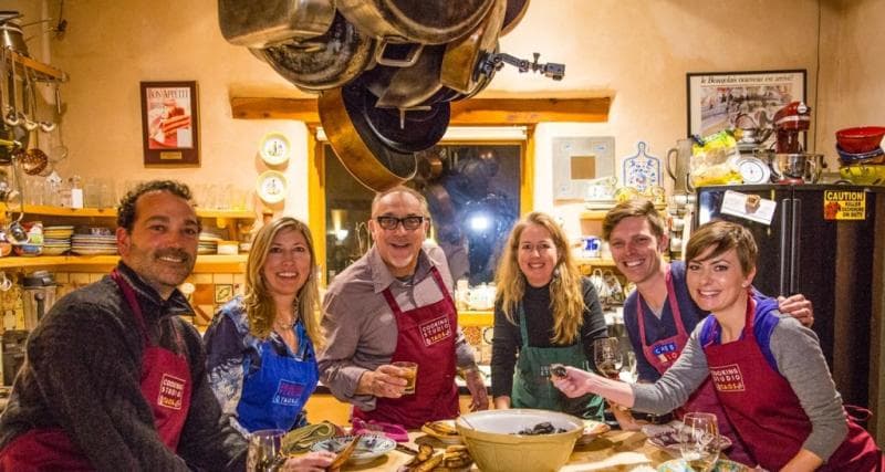 Chef and students gathered around a food spread at Cooking Studio Taos