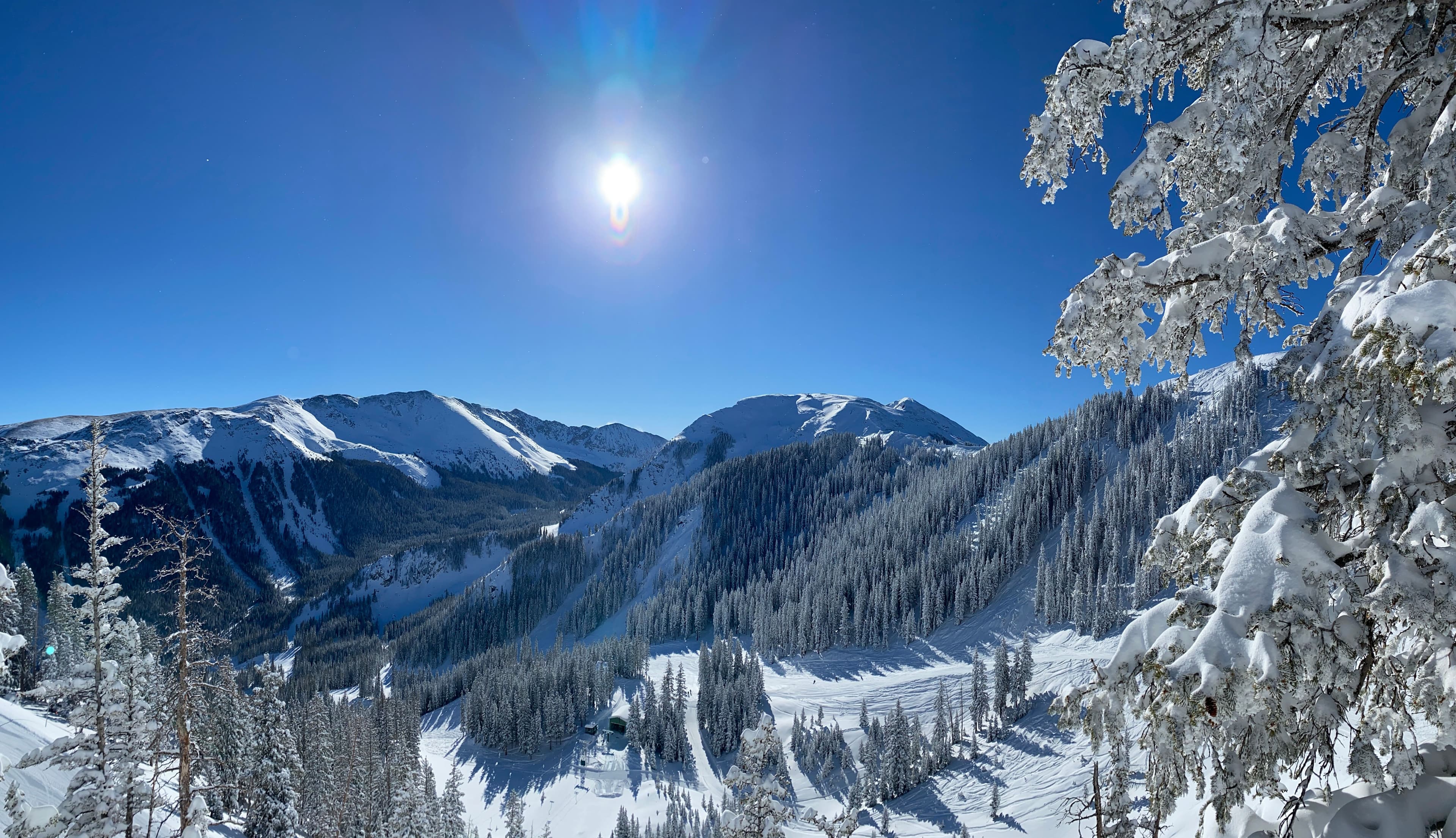 Scenic shot of the snowy mountains on a clear sunny day