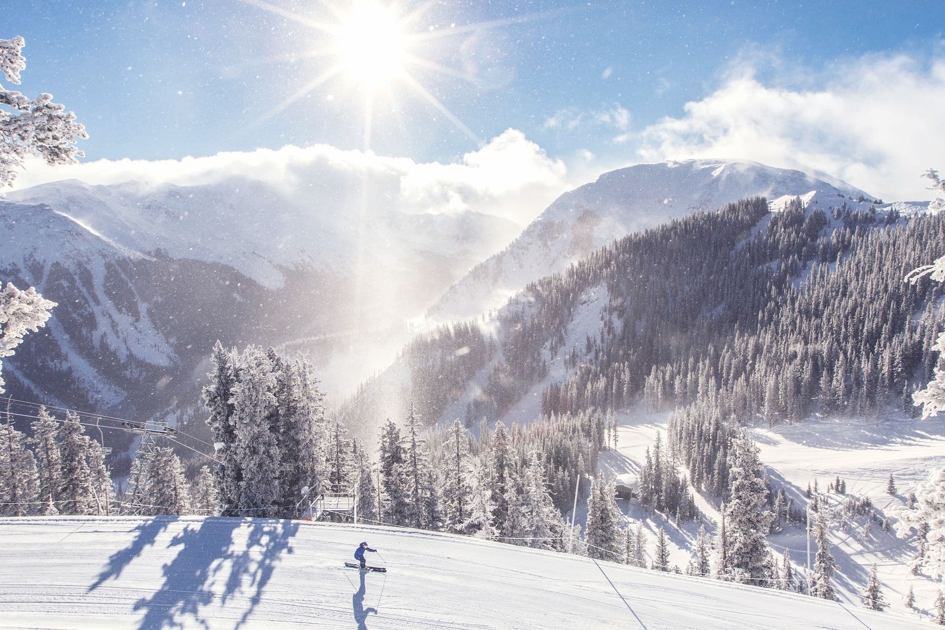 Skiier on a groomed run under the legendary Kachina Peak at Taos Ski Valley