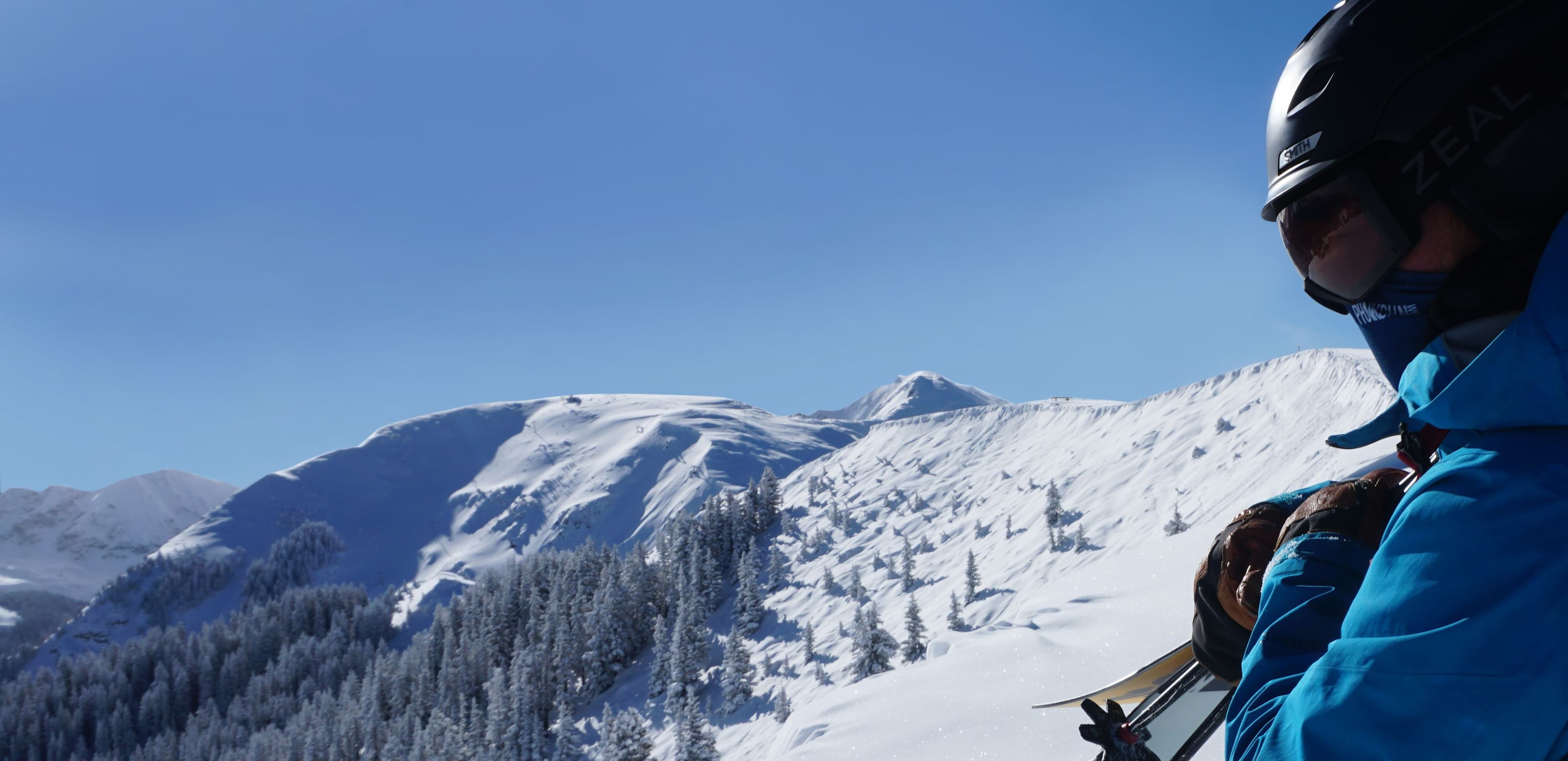 Hiker enjoys view of Highline ridge on Bluebird day in the Rockies.