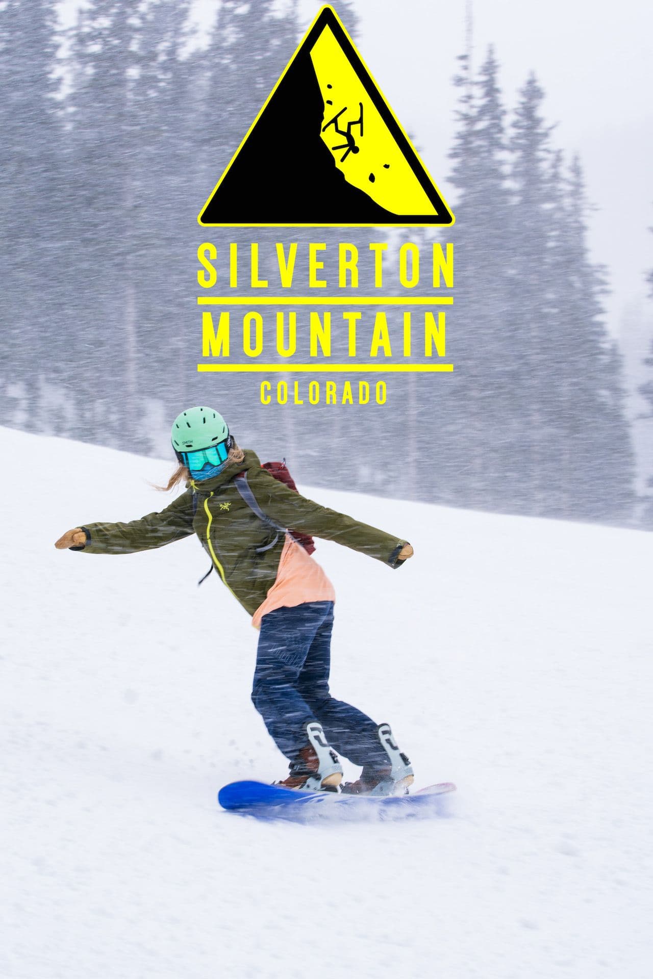 A snowboarder rides down a run.