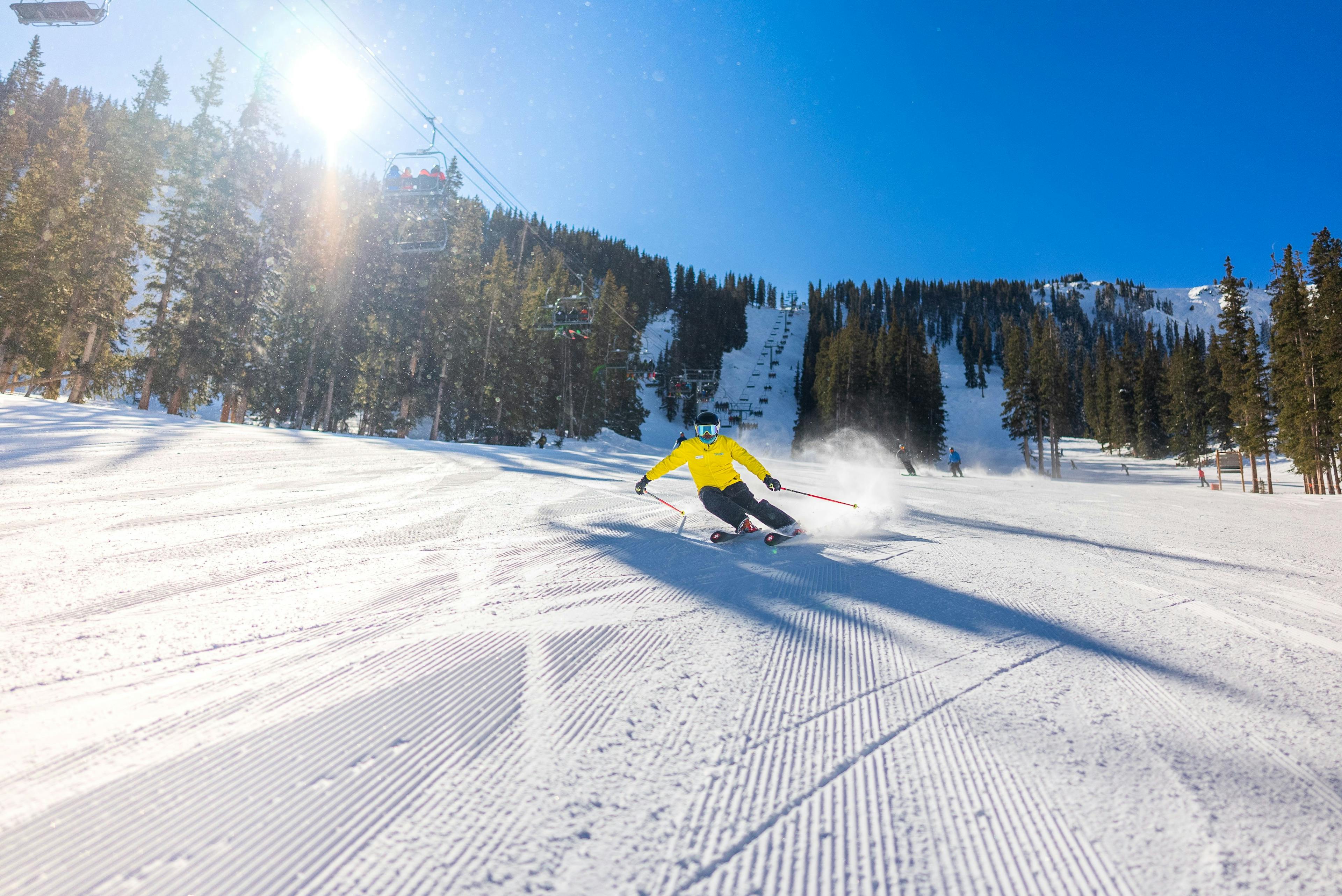 Snowsports instructor demonstrates tight ski racing turns on a groomer