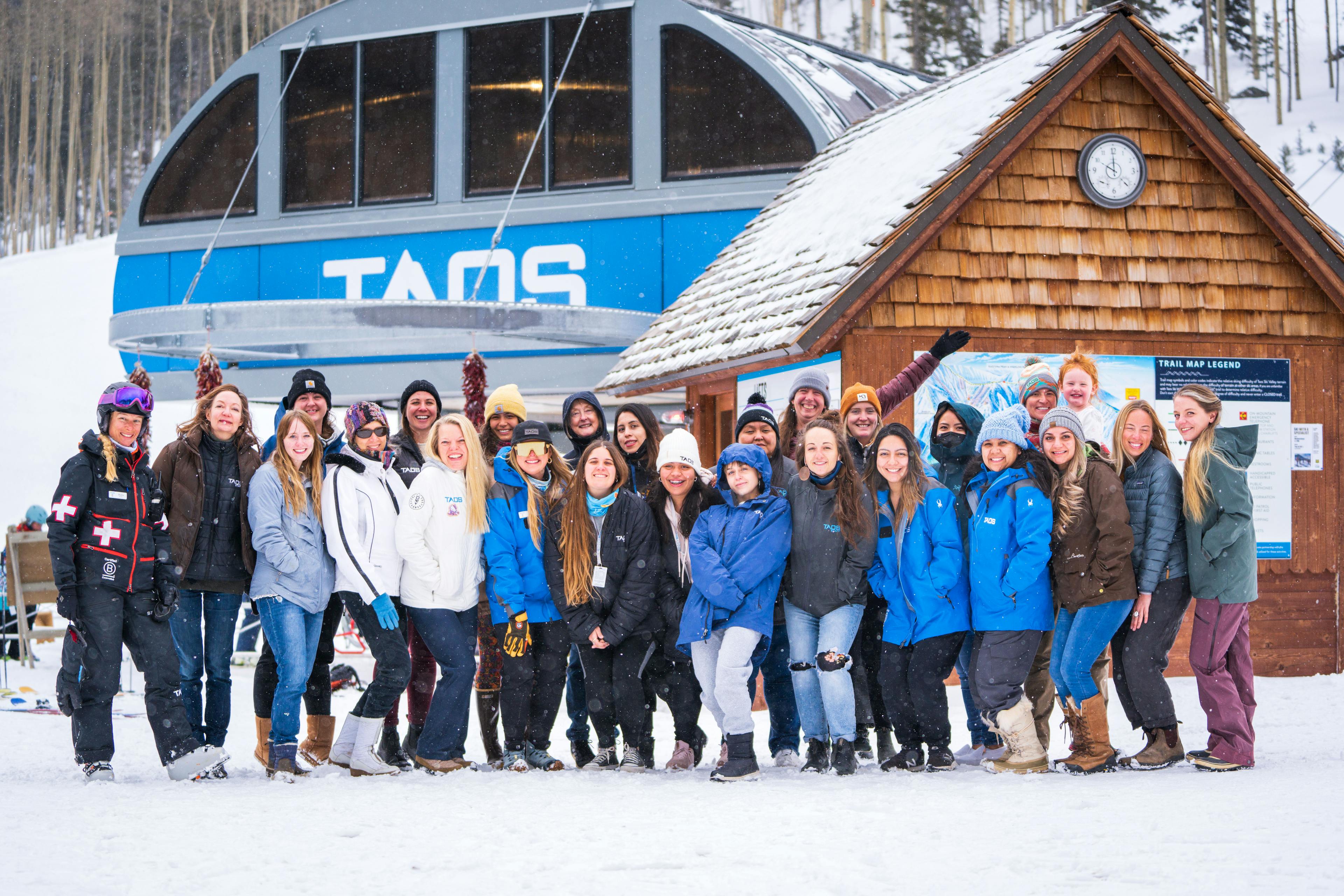 Female employees in front of Lift 1 at Taos Ski Valley.