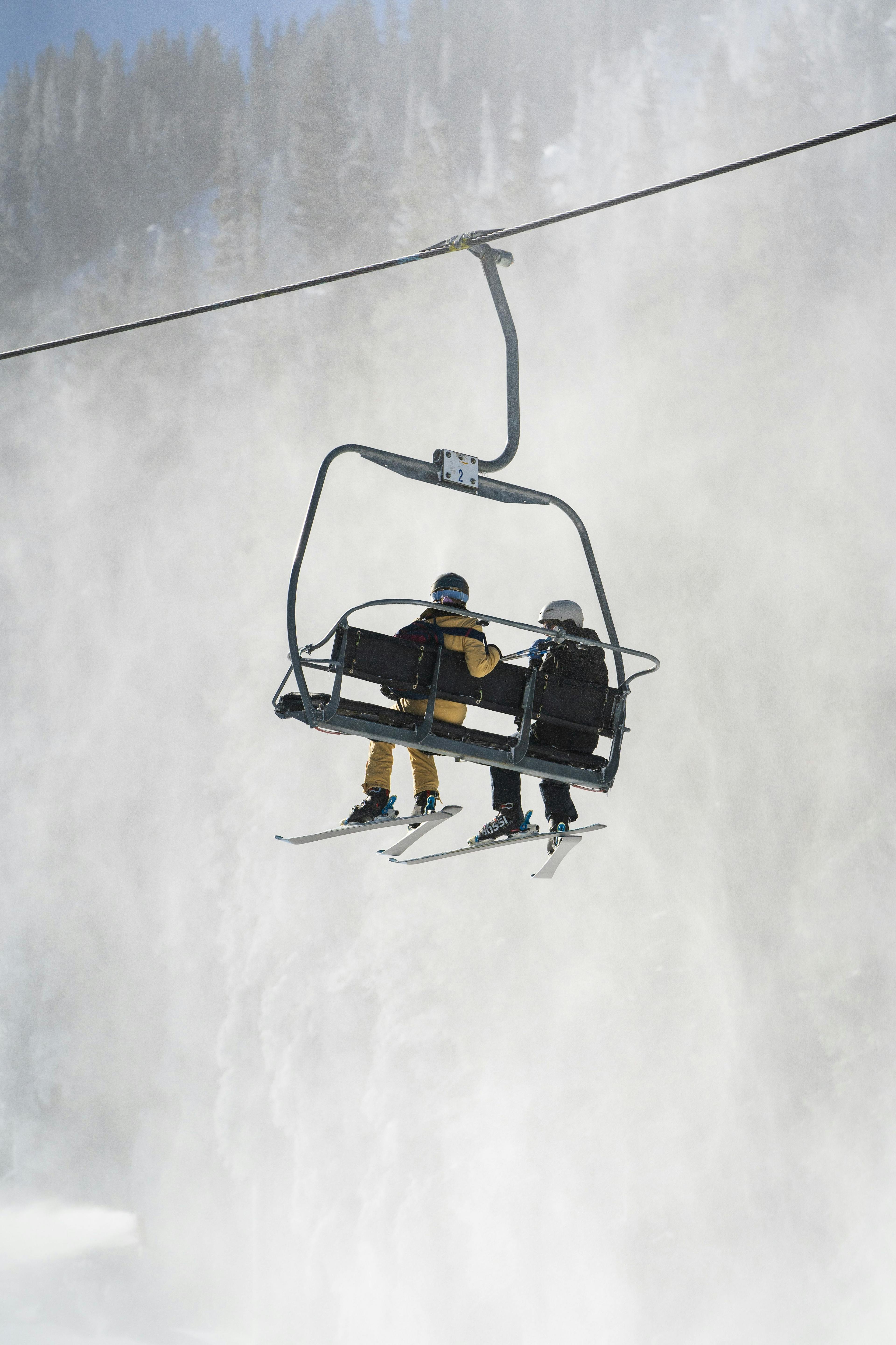 skiers riding the lift on a snowy day