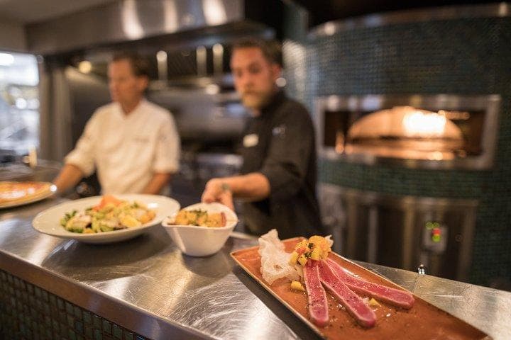 Chefs at 192 making and preparing food.