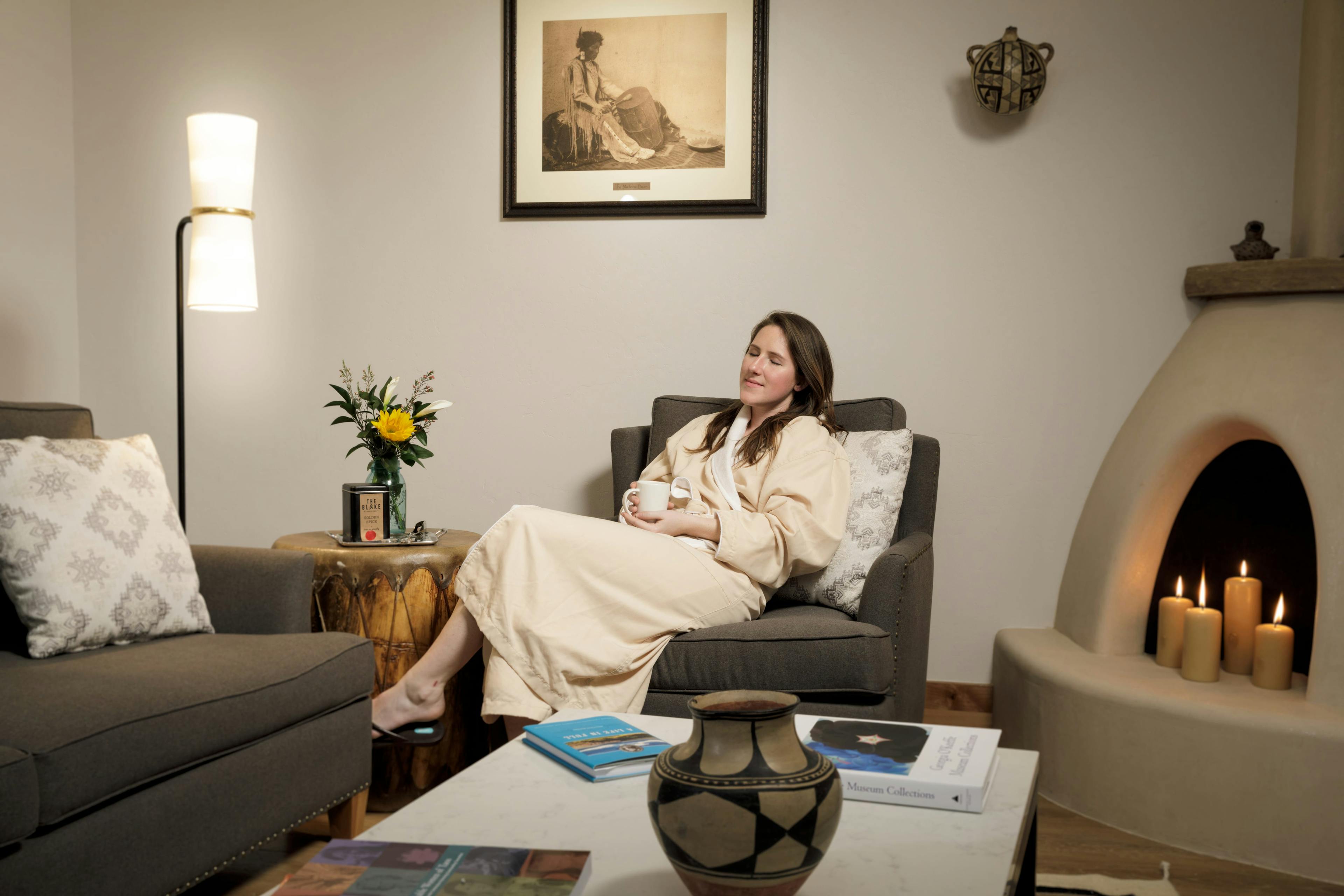 Mother-to-be in a robe enjoys a relaxing tea in the lounge area of The Spa