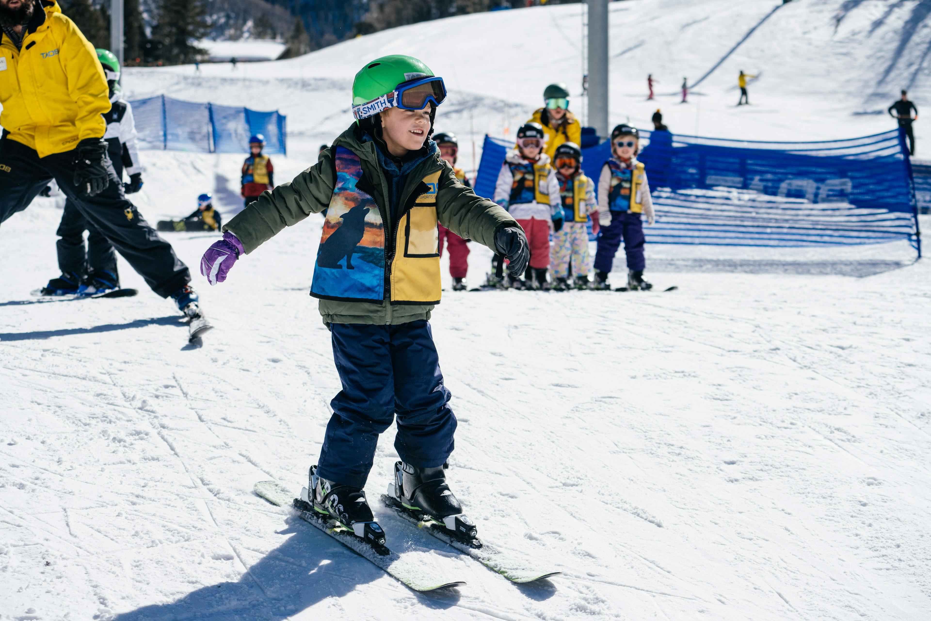 A child learning to ski with a class at Taos Ski Valley.