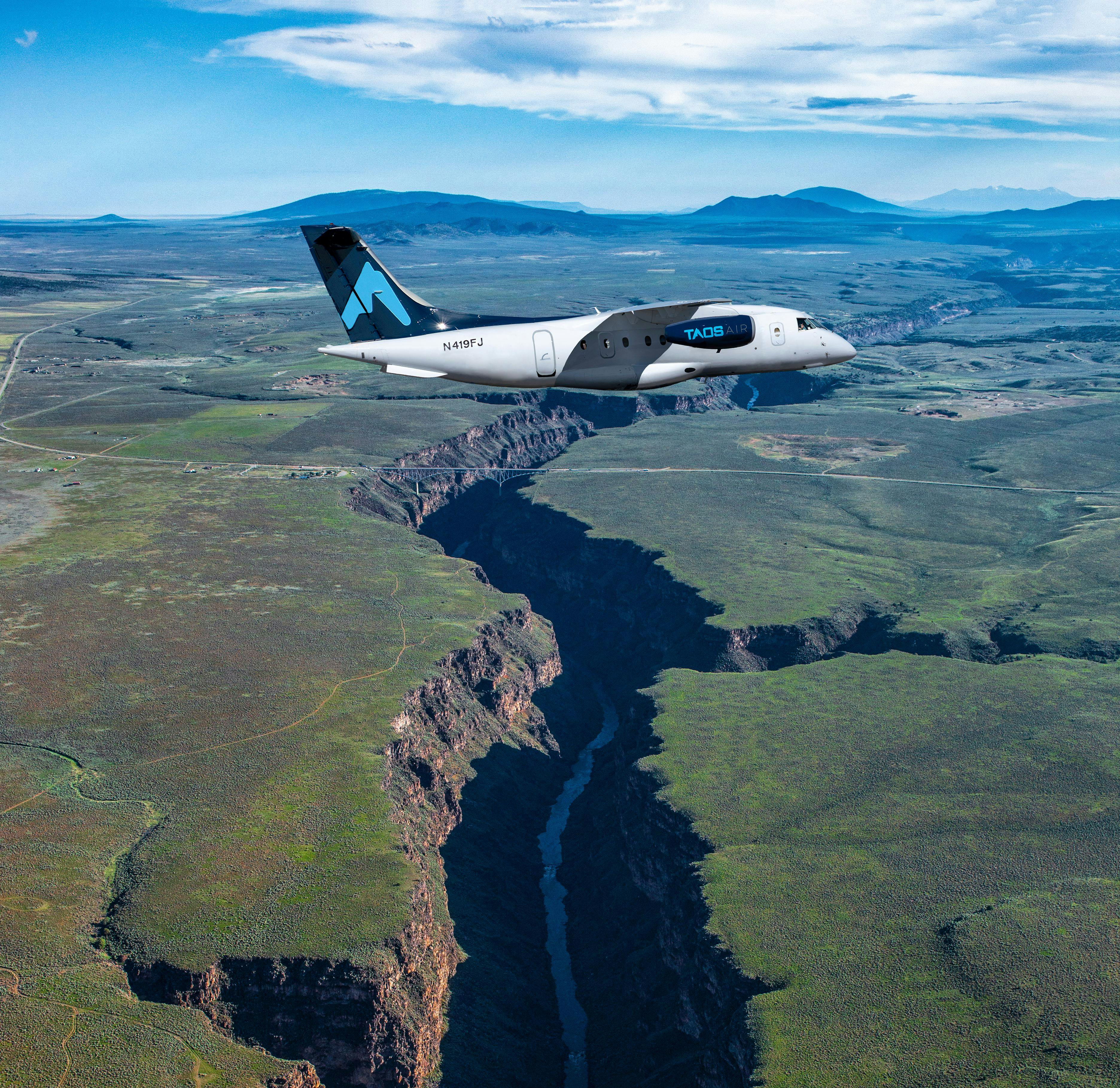 Taos Air JSX plane flying over rio grande gorge
