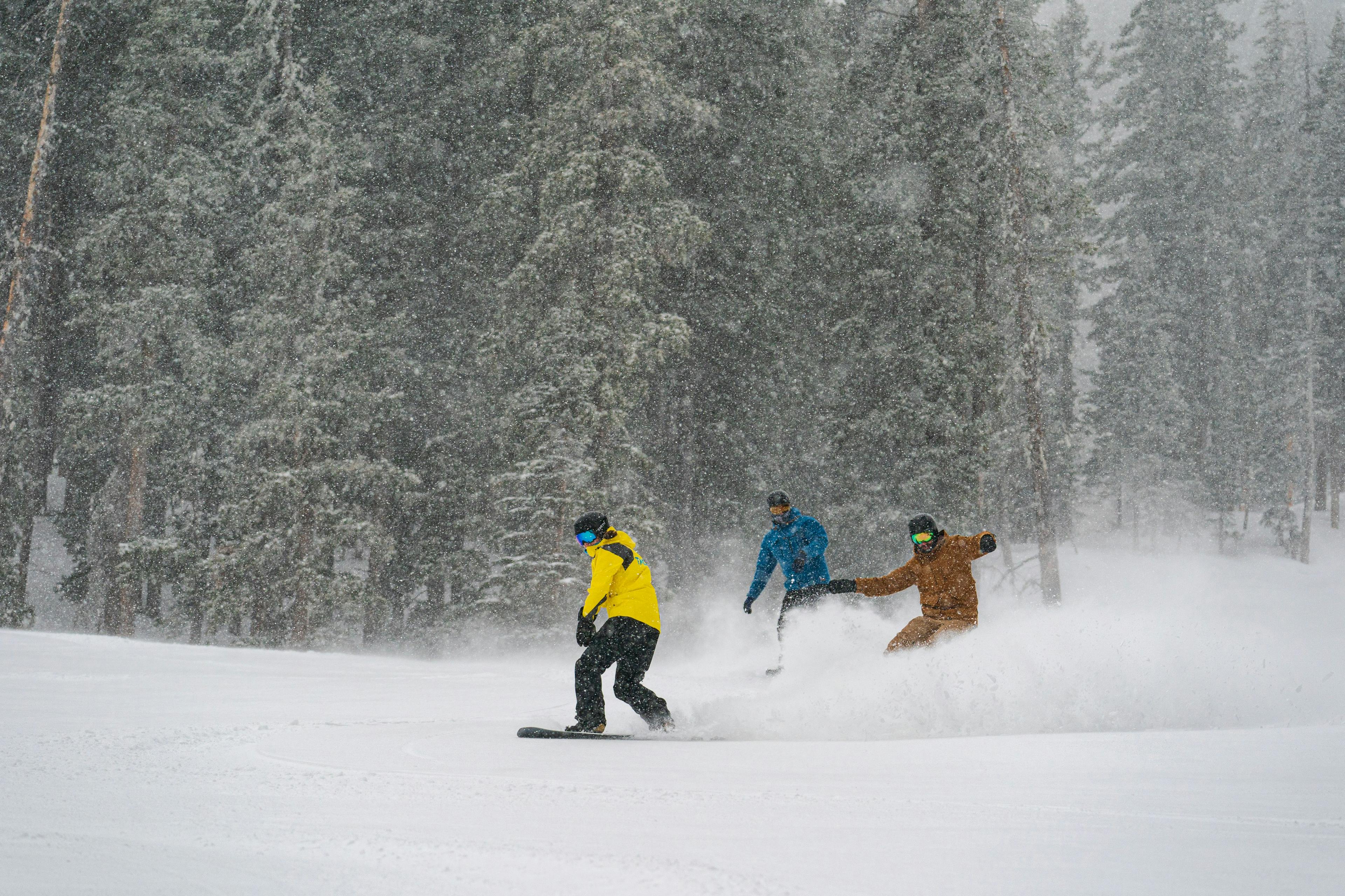 Snowboarders enjoying powder in a lesson at Taos Ski Valley.