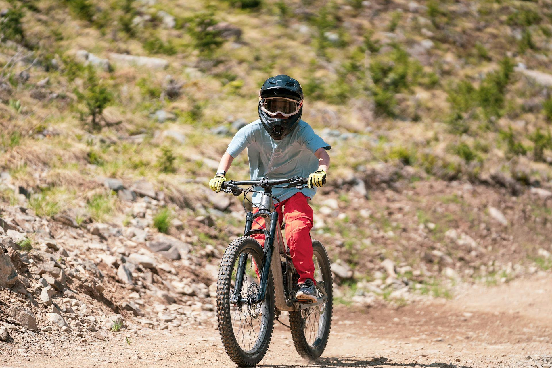 Young child rides a small mountain bike at Taos Ski Valley
