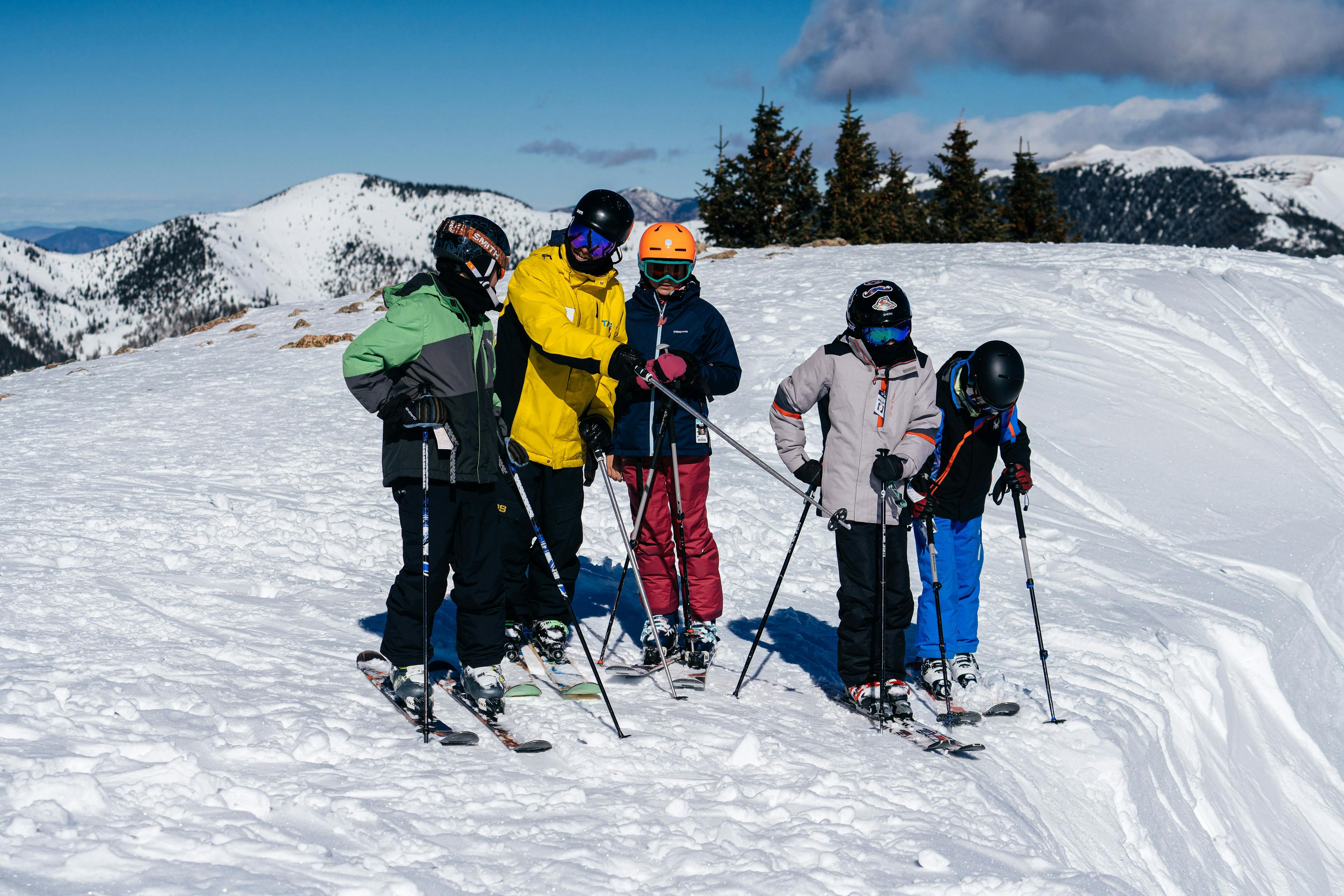 Snowsports instructor explains responsibility code to young skiers on the mountain