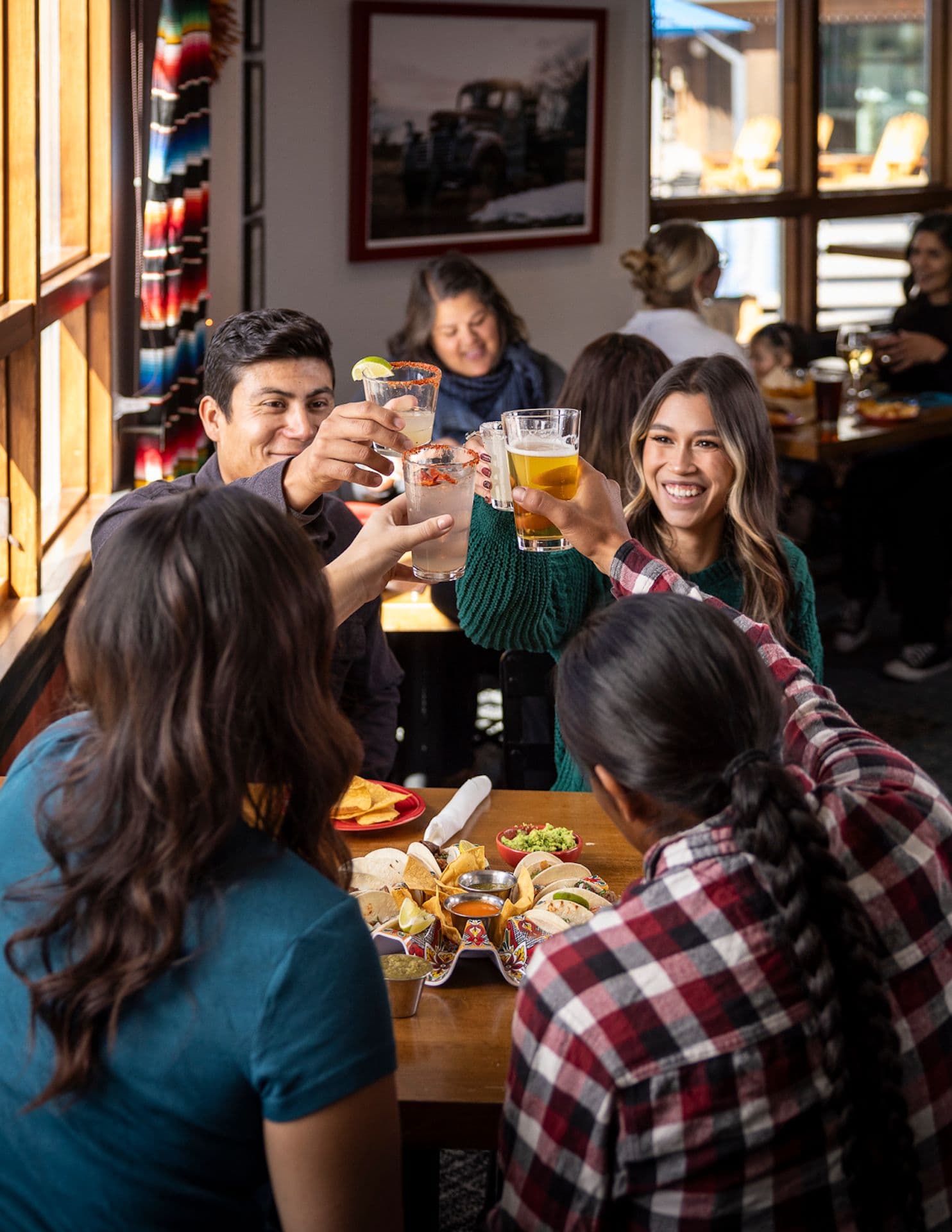 Group of friends cheersing at Rhoda's at Taos Ski Valley