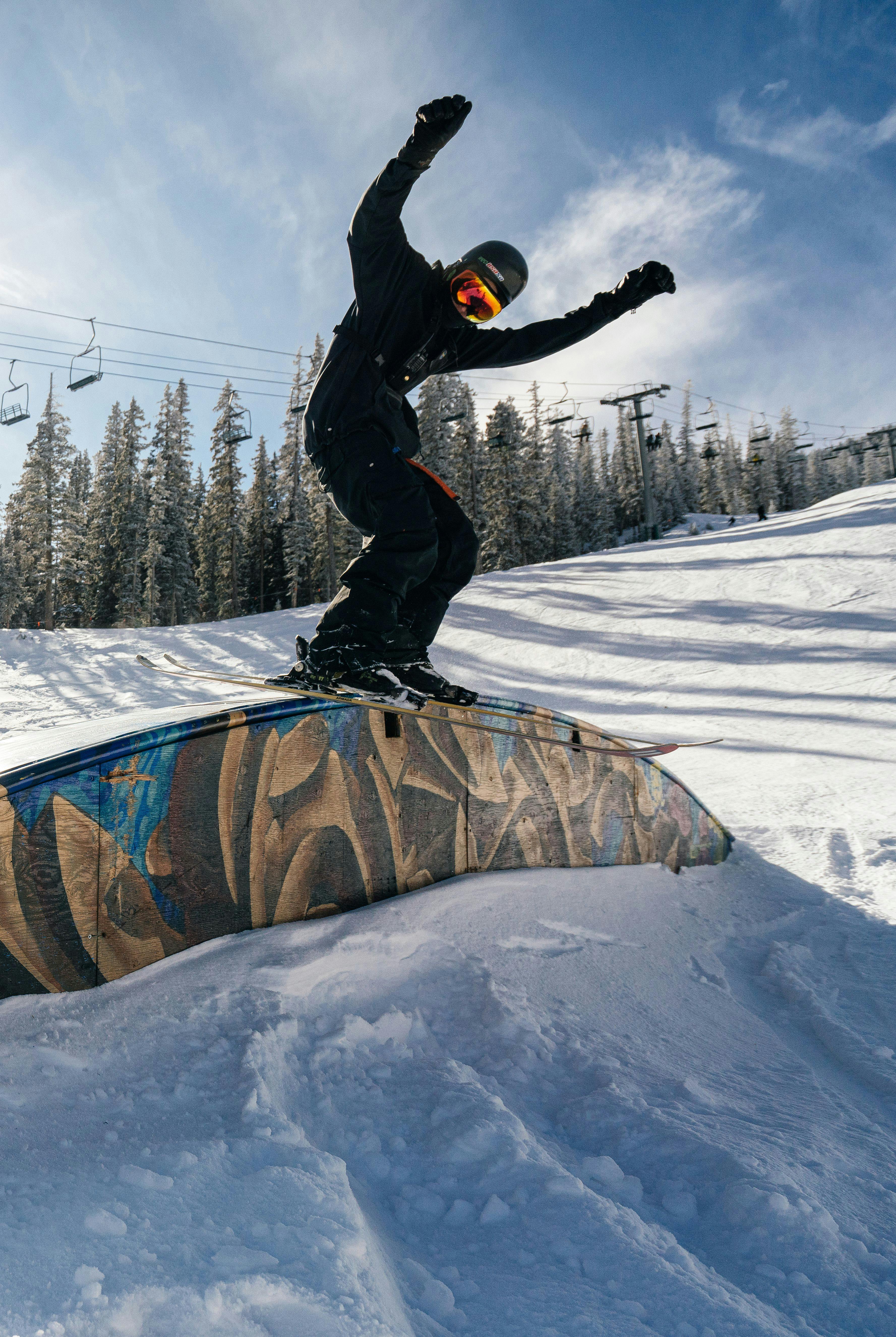 Snowboarder hitting a rail in the terrain park