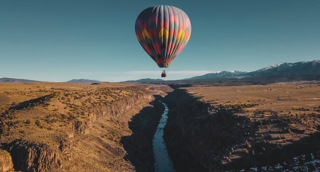 Hot air balloon flying over the rio grande gorge